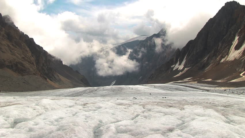 Timelapse landscape with white clouds and high mountain