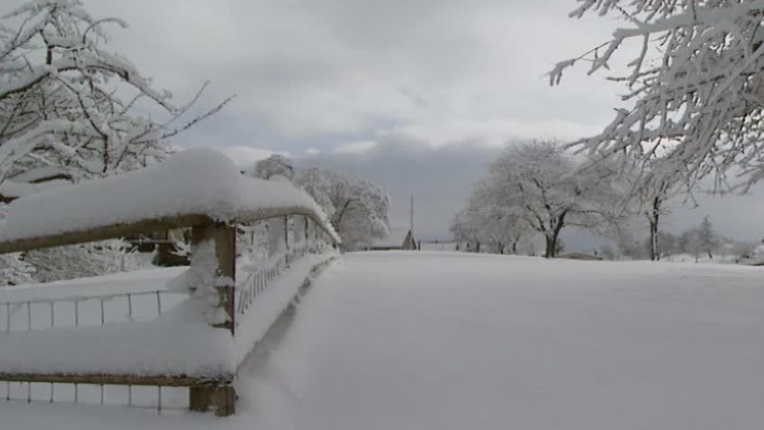 thick layer of snow on railing bridge pan snowy chalets in  village