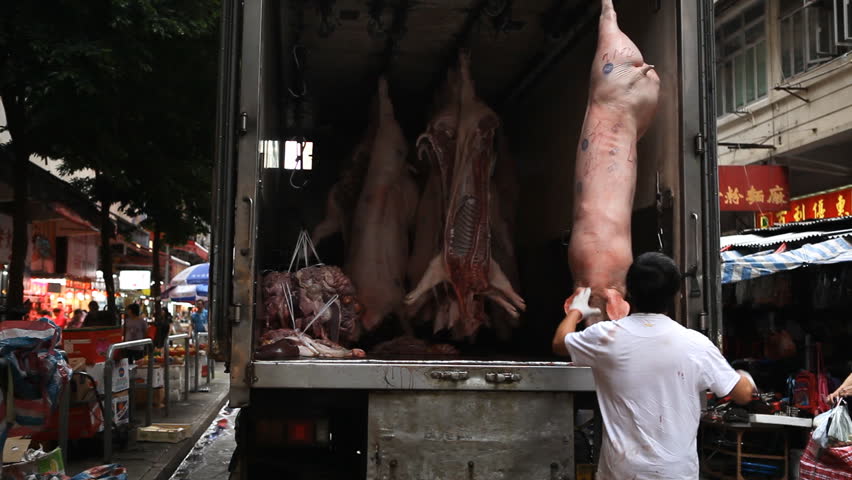 HONG KONG - MAY 19, 2012 Hong Kong Market Street, Man Sell Fresh Pork Meat to Butchery Shop