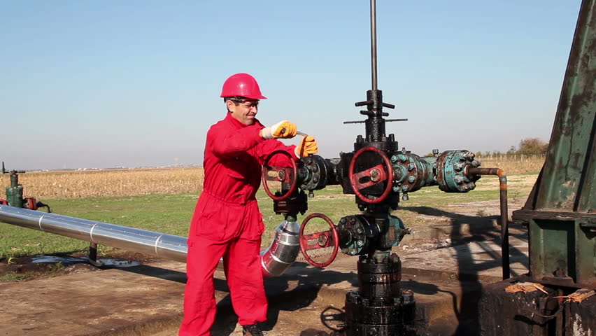 Man Working on Oil Field Equipment.
Oil worker in action at oil well. HD1080p.