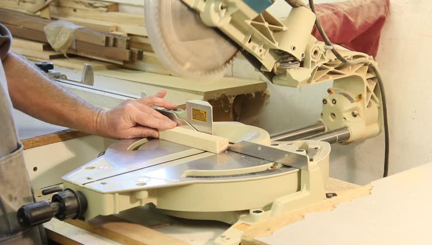 miter trim saw cutting a cabinet board