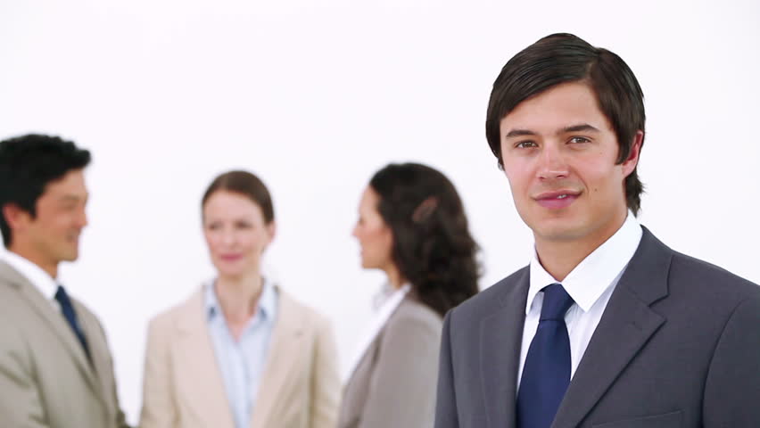 Businessman Laughing with co-workers in background