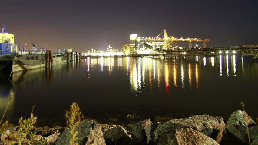 Time Lapse of Loading Sand into Trailer Boats with Downtown Vancouver in the Background. Shot in 4k RAW photo sequence