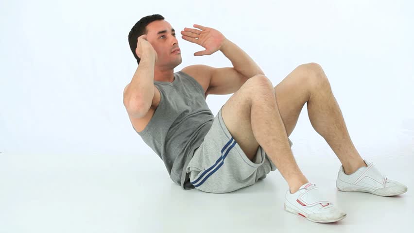 Sportsman exercising abs against a white background
