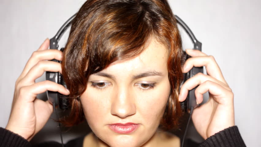 Girl in headphones, looking into camera
