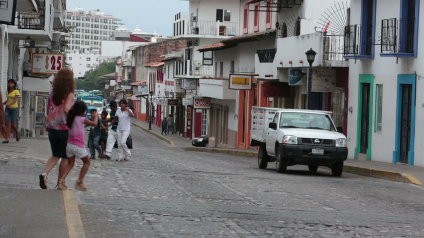 PUERTO VALLARTA, MEXICO - NOV 4: Busy Mexican street with traffic, cars, trucks and bus. Commercial area of Puerto Vallarta, Jalisco, Mexico on November 4, 2012.