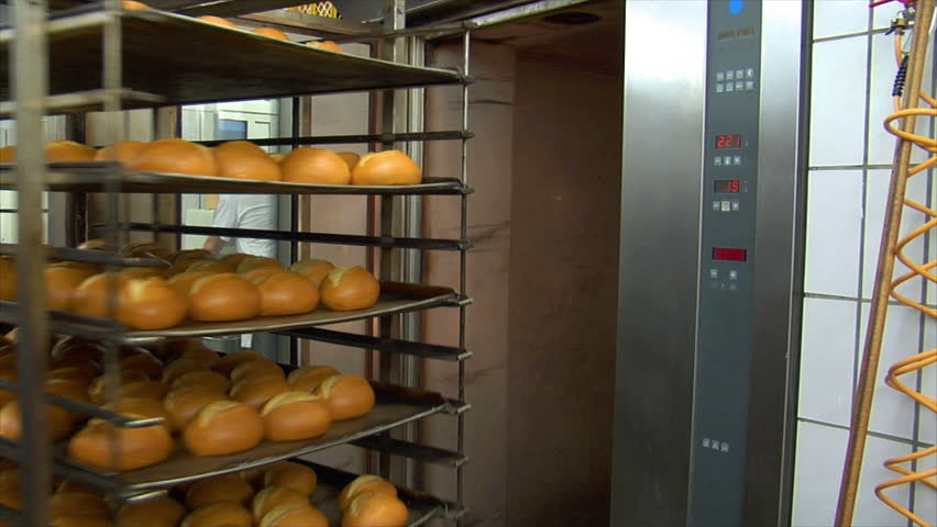 Baker takes roll bun out of a rotary oven. You will find even more GERMAN BAKERY clips in my portfolio!
