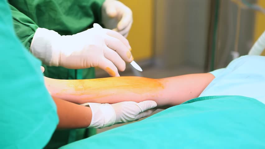 Surgeon operating a patient in a surgical room