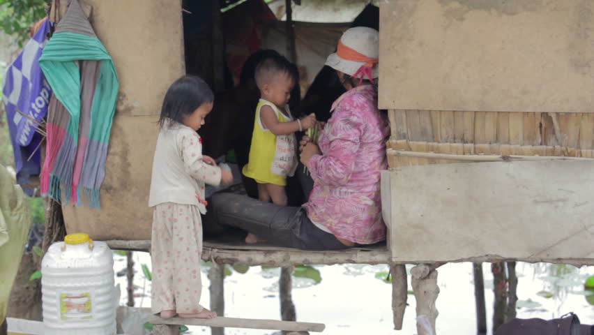 Cambodian family in slum, inside shack