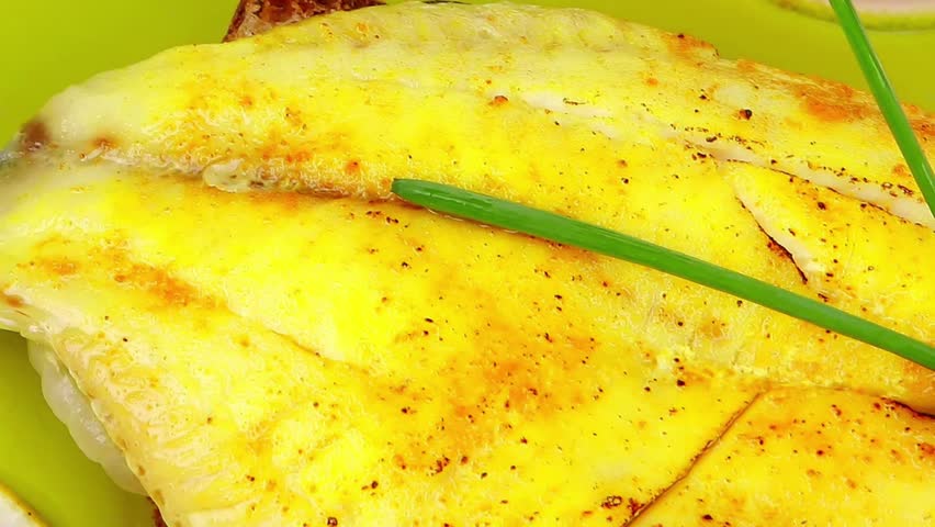 savory: fish fillet with tomatoes chives and lemon on plate
