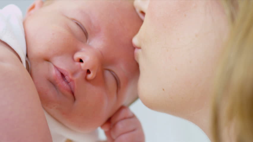 Portrait Mother Kissing Baby Daughter