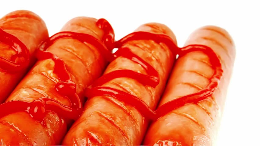 served beef red sausages with ketchup over white