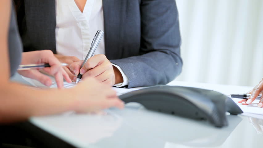 Business team make conference call on speaker phone