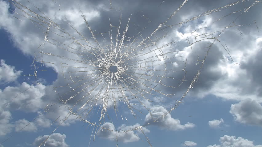 Broken window, cracked glass against sky time lapse