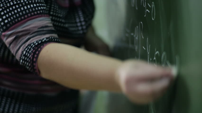 Teacher wrote in chalk on a blackboard
