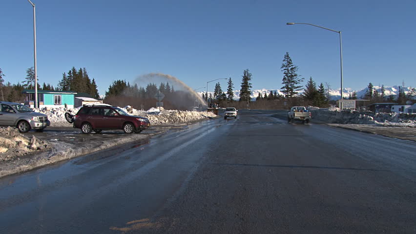 HOMER, AK - CIRCA 2012: This snow blower is clearing the sidewalk next to the Homer Bypass/Sterling Highway.