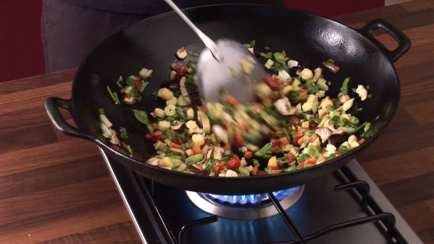 Stir-frying vegetables in a wok