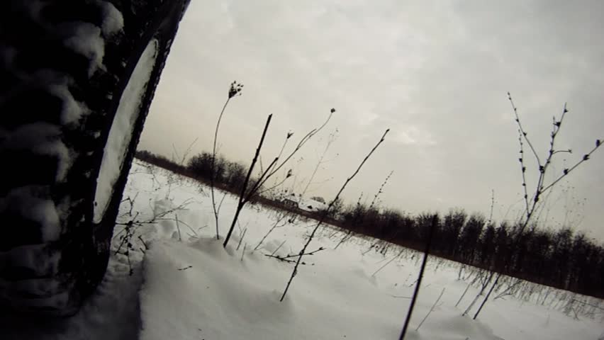 Offroad driving through snowy lowland