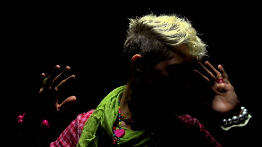 Super 35mm camera - Attractive young woman dancing aggressively in the dark