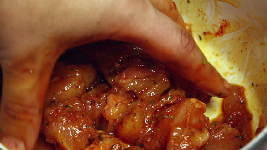 Super 35mm camera - seasoning chicken meat and mixing it by hand