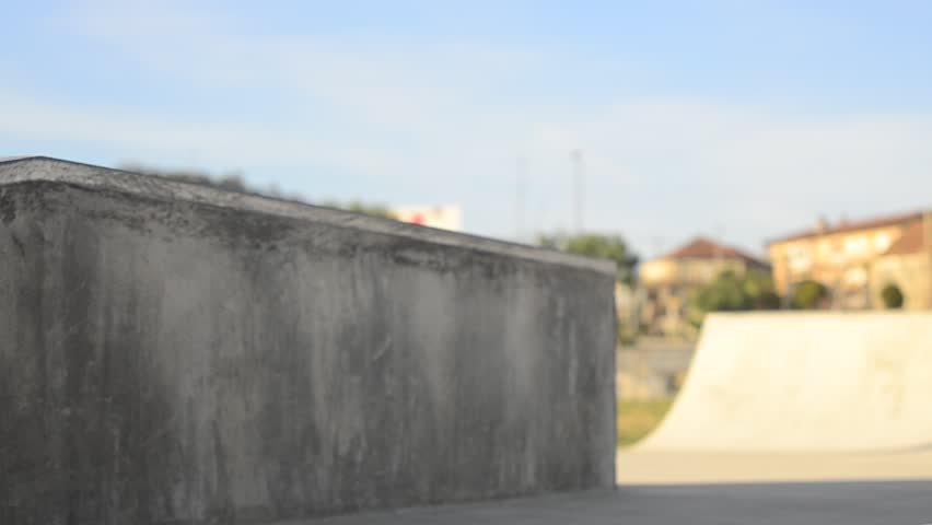 Bmx rider grinding on a concrete park on a sunny day.