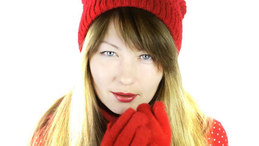 frozen beautiful girl in a red hat and gloves, rubbing his hands