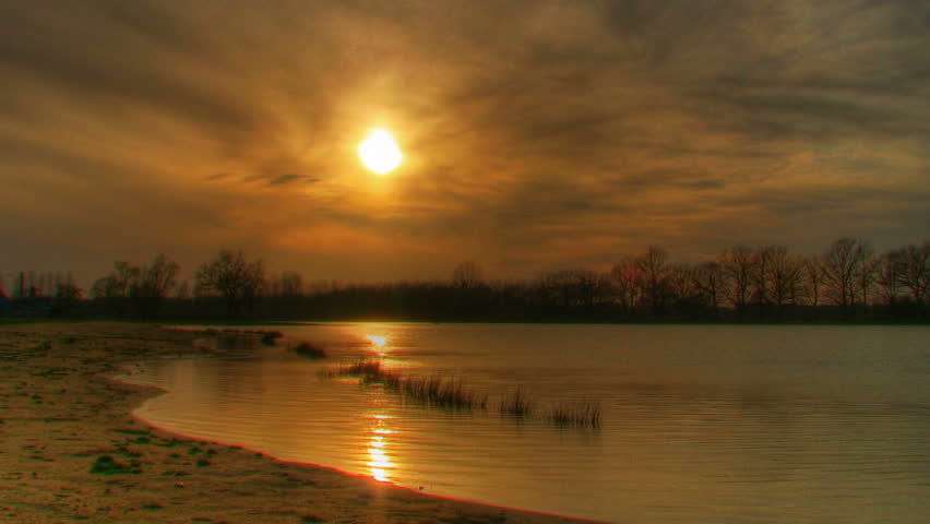 Sunset over water, HD time lapse clip, high dynamic range imaging