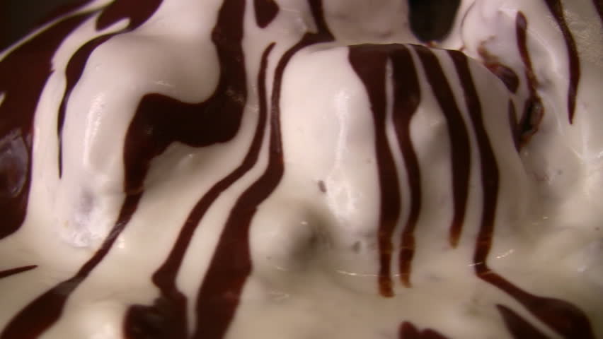 Cream-chocolate frosting on cake, rotating 
