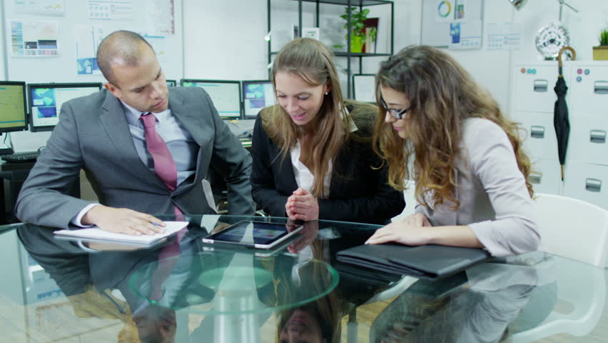 three professional business people are awaiting news on the outcome of a project that they have been involved with. They find out that they have been successful.