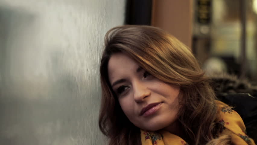 Pensive young woman riding the tram, steadicam shot