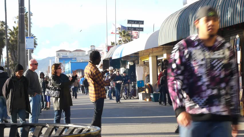 VENICE BEACH, CALIFORNIA - CIRCA 2011:  Tourists and locals walk on the boardwalk at Venice Beach, CA .
