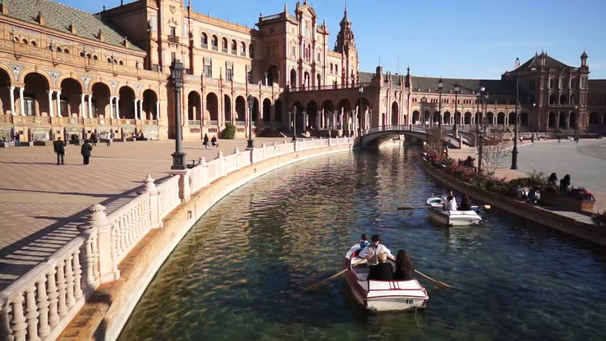 SEVILLE, SPAIN - JANUARY 6: Tourists enjoy a trip on boat on Plaza de Espana Seville on Jan 6, 2013 It was built in 1928 for the Ibero-American Exposition of 1929 designed by architect Anibal Gonzalez