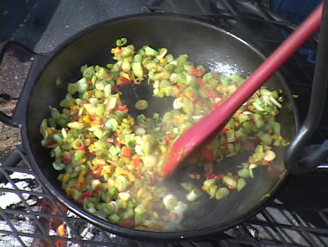Vegetable mixture being cooked over an open fire