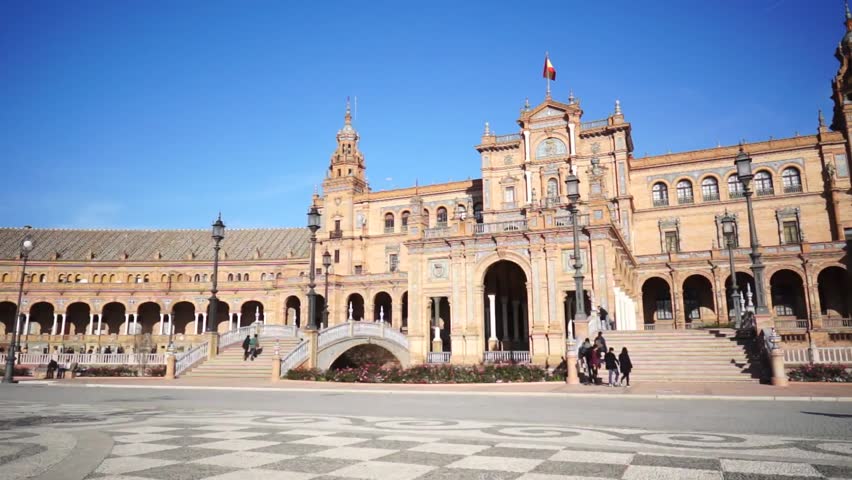 SEVILLE, SPAIN - JANUARY 6: Tourists enjoy a trip on horse drawn cart on Plaza de Espana. It was built in 1928 for the Ibero-American Exposition of 1929 designed by famous architect, Anibal Gonzalez.