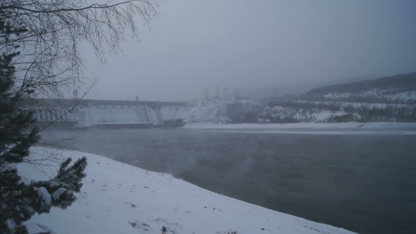 Krasnoyarsk Hydropower Plant on Yenisei river in frosty windy winter day. Town of Divnogorsk, Siberia, Russia. January 03, 2013. 