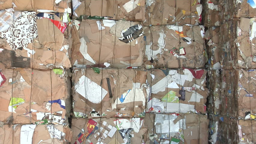 Stack of  recycled cardboard sorted in cubes at recycling plant.
