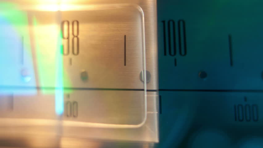 a glowing radio with the marker running through the different stations and frequencies