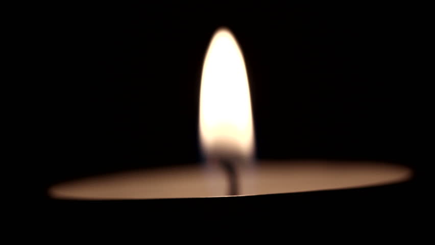One tea candle. Blurred scene