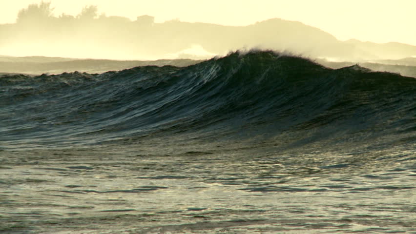 HAWAII, USA, 2012 Large waves crest and break on a shoreline.