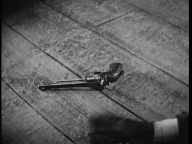 Man trying to reach handgun on floor
