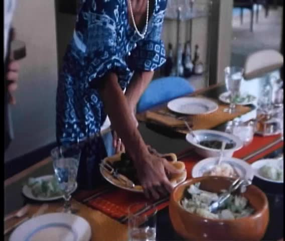 Midsection of woman placing fresh food on table