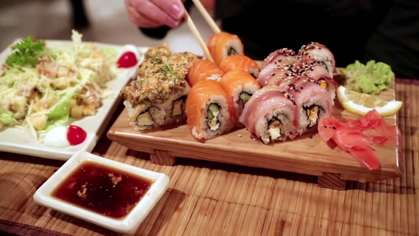 Woman eating sushi in a restaurant