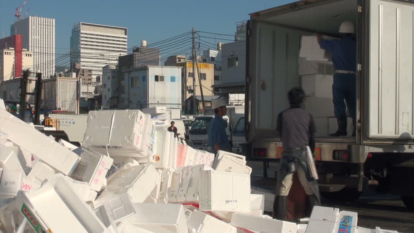 TOKYO, JAPAN - 7 NOVEMBER 2012: Unloading a truck with foam boxes for recycling at the Tsukiji fish market in Tokyo