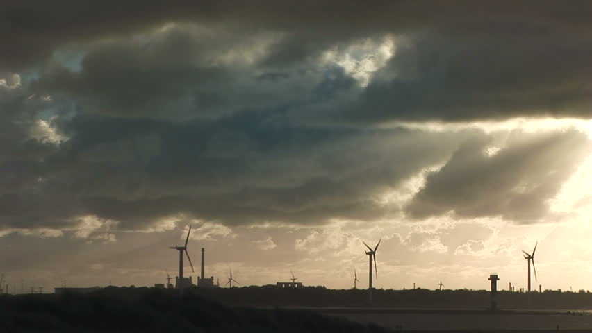 Dutch wind Turbines across the mouth of the Rotterdam waterway with heavy clouds, The Netherlands