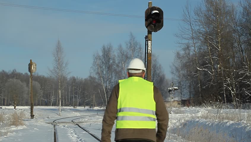 Railroad worker checking signal beacons