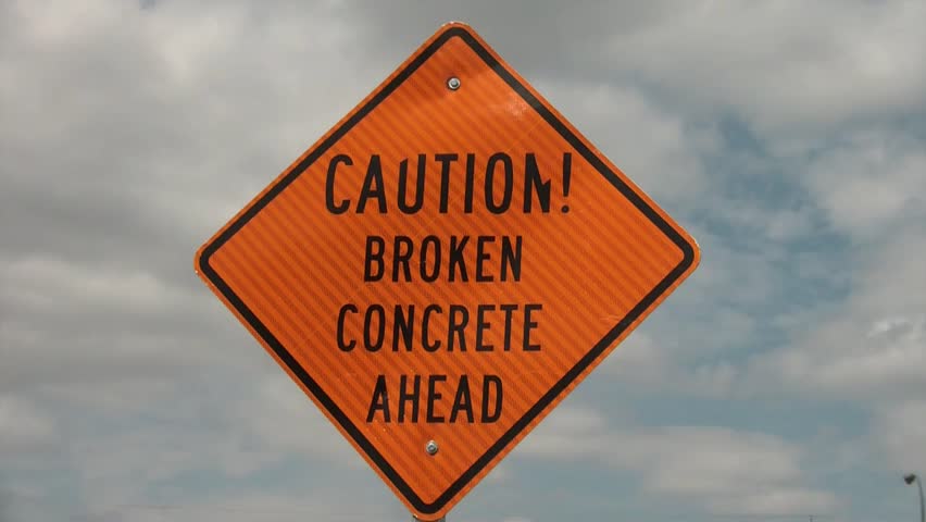 Guy falls off bike in spoof after sign reads caution broken concrete.