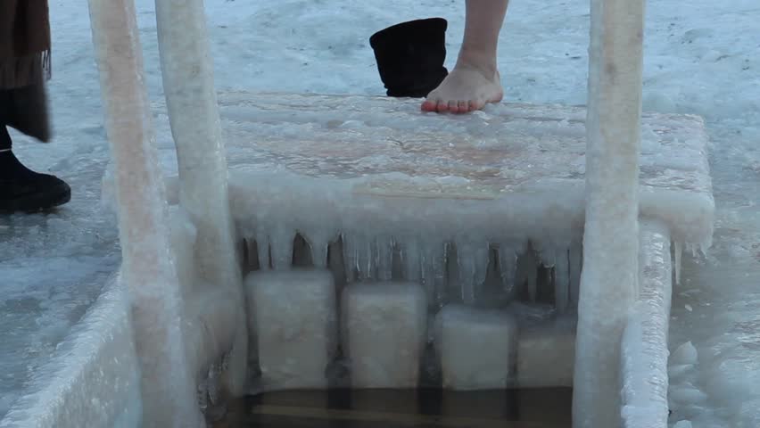 ST PETERSBURG - JAN 19: The woman bathing  in an ice-hole on January 19, 2013 temperature of -14 degrees, the river Neva, St. Petersburg Russia