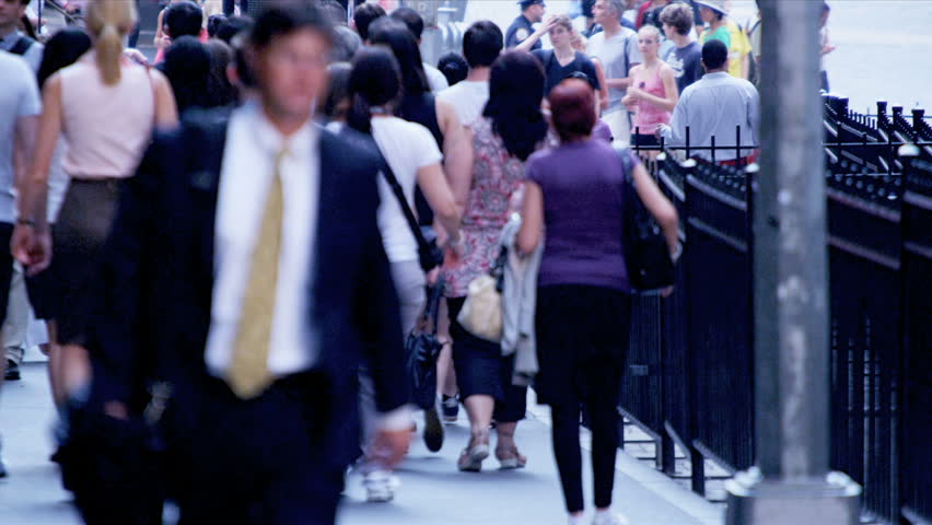 New York - August 21, 2012: Business commuters on busy city sidewalk on Wall Street 