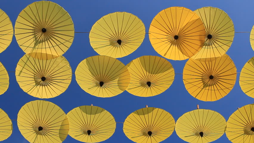 yellow umbrellas against a bright blue sky