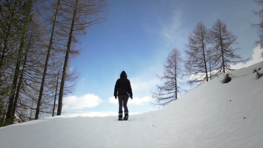 Man searching a prey to hunt on the snowy mountain in winter